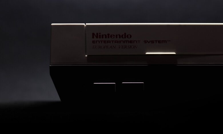 A retro close-up shot of a classic Nintendo Entertainment System in low light.
