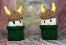 Two cute knitted Viking dolls with horned helmets in bright colors, perfect for crafts or decor.