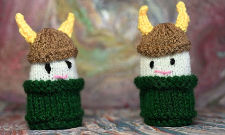 Two cute knitted Viking dolls with horned helmets in bright colors, perfect for crafts or decor.