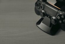 Black PS4 controller on display stand with copy space