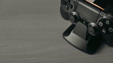 Black PS4 controller on display stand with copy space