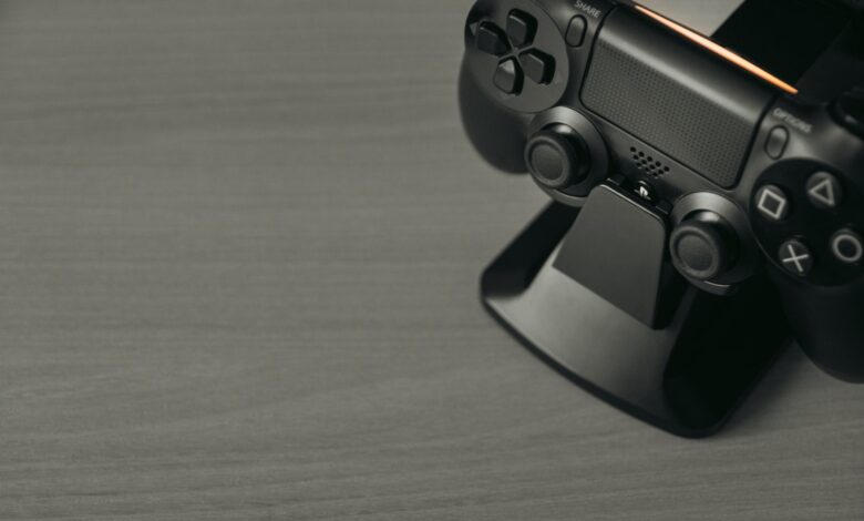 Black PS4 controller on display stand with copy space