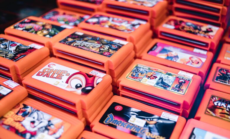 Close-up of stacked retro video game cartridges in orange cases, showcasing popular titles.