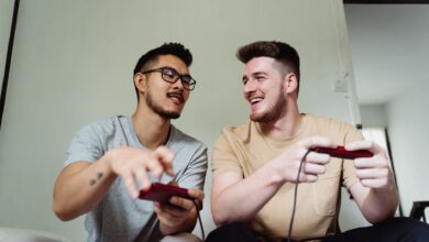 Two friends having fun playing video games in a relaxed home setting.